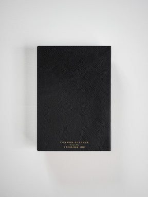 Black, textured faux leather common planner featuring a minimalist design and branding for the 2026 academic year.