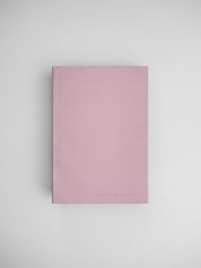 Minimalist blush pink daily planner notebook featuring clean lines and "DAILY PLANNER" branding on the cover.