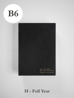 Sleek black B6 academic planner with a textured cover, stamped with the 26-27 academic year and "Common Planner" branding.