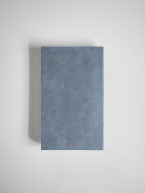 Muted slate blue B6 planner with a textured, compact cover and elegant gold embossed branding, perfect for tracking your 2026 full year schedule.