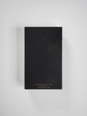 Elegant, black planner featuring a smooth, matte cover and centered gold foil lettering that reads 'COMMON PLANNER' and the brand name.