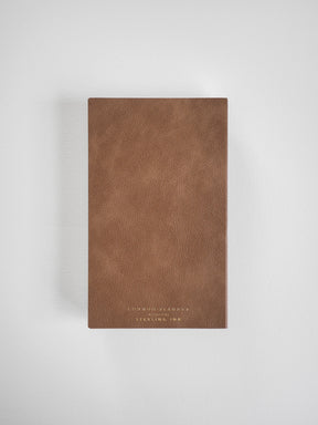Rich cognac brown B6 planner with a minimalist, solid cover featuring debossed text reading "COMMON PLANNER" and "STERLING INK."
