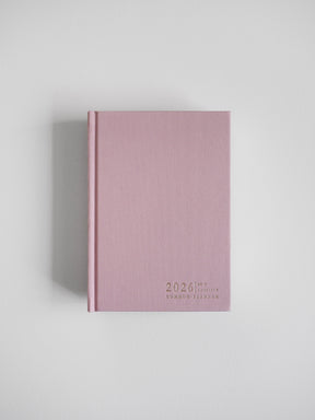 Dusty rose, vertical planner featuring the year 2026 and "Common Planner" in minimalist typography, ready for organization.
