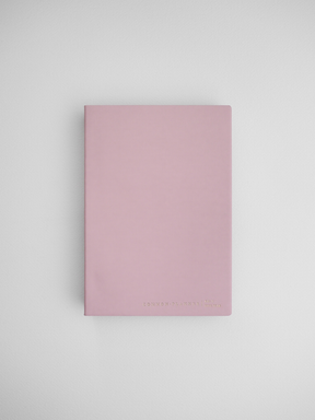 Minimalist blush pink planner notebook featuring a solid cover and "Common Planner London" branding, ideal for year-at-a-glance planning.