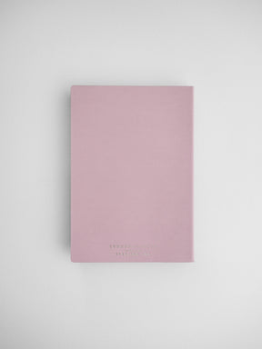 Elegant, blush pink B6 vertical planner journal with subtle gold typography, featuring a clean and minimalist design for organization.