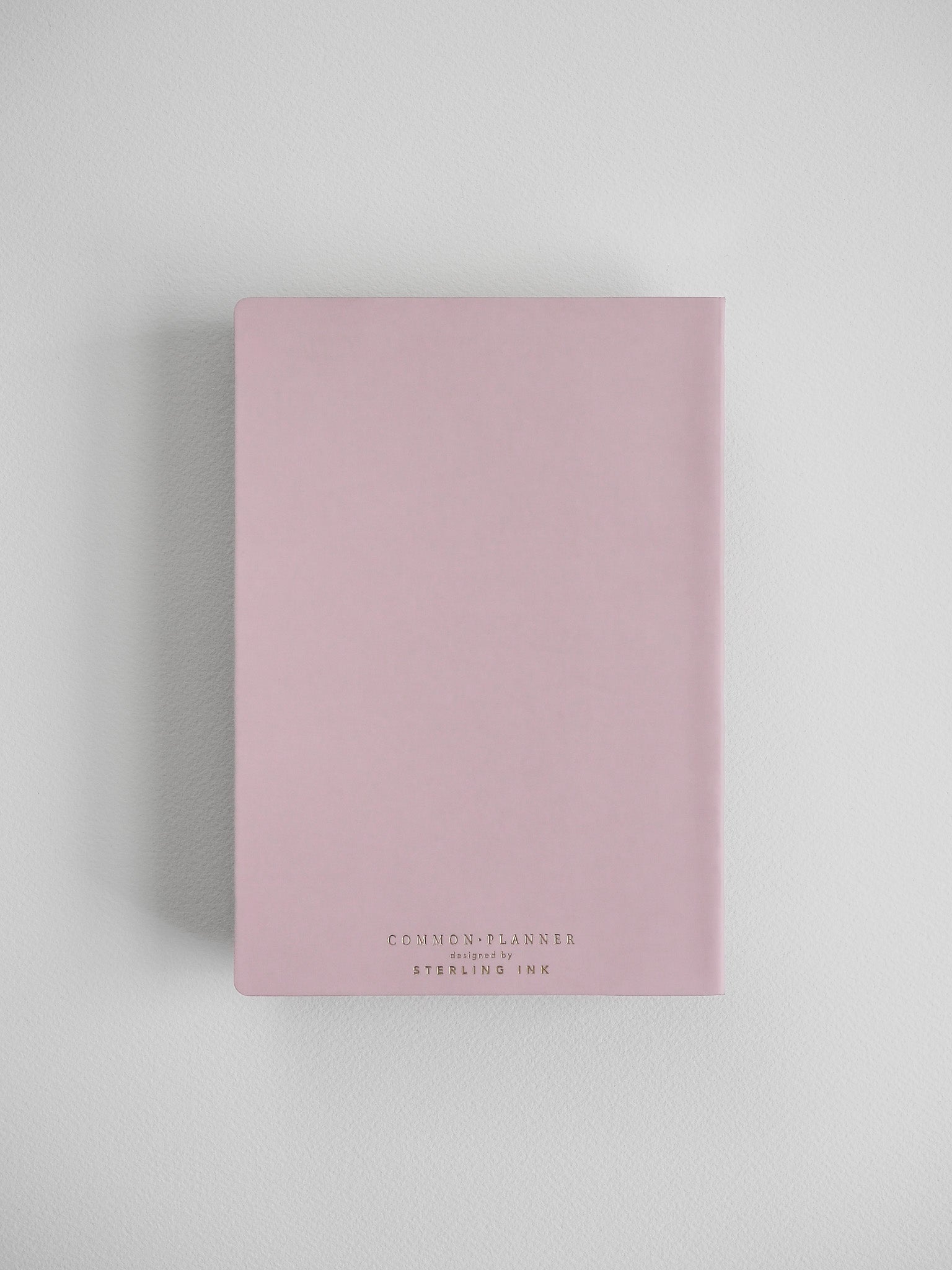 Elegant blush pink B6 vertical planner cover featuring centered branding text that reads "COMMON PLANNER" and "STERLING INK."