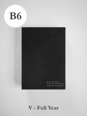 Minimalist black B6 academic planner cover, textured like faux leather, featuring debossed 2026-2027 details for the full year.