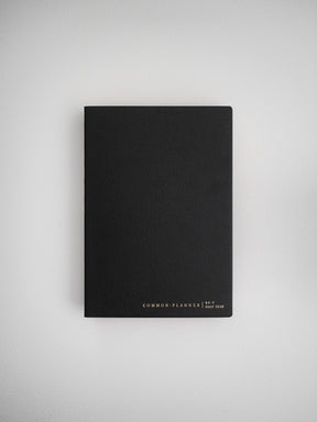 Minimalist black B6 common planner cover for half year scheduling, featuring elegant centered branding for an organized aesthetic.