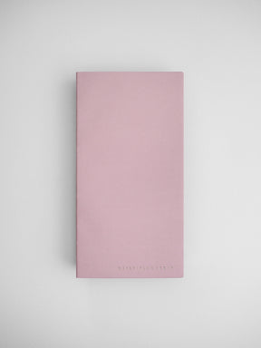 Blush pink undated daily planner notebook with a solid, minimalist cover and "DAILY PLANNER | N1" branding printed near the bottom.