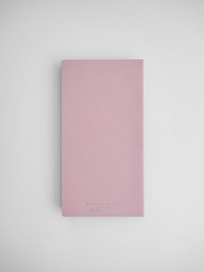 Soft blush pink common planner notebook cover, featuring minimalist black branding for an organized full-year journal.
