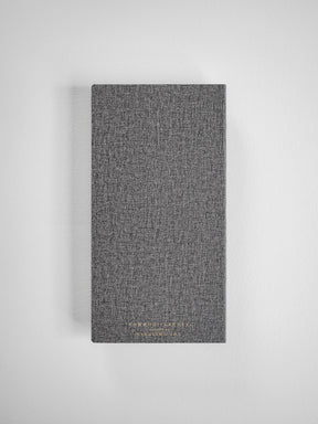 Dark gray textured planner with a woven finish, featuring subtle gold metallic lettering for the 2026 Common Planner.
