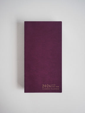 Deep burgundy planner cover featuring minimalist white text announcing "2026 Full Year Common Planner."