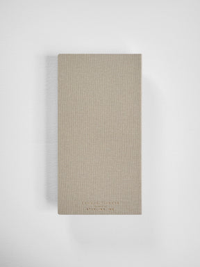 Minimalist beige planner for 2026, featuring a vertical, linen-textured cover and subtle brand lettering from Edmond Planner.