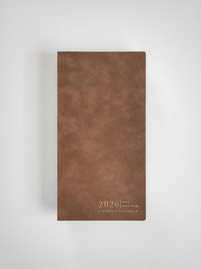 Textured tan faux leather planner cover featuring "2026 Full Year Common Planner" embossed across the vertical front.