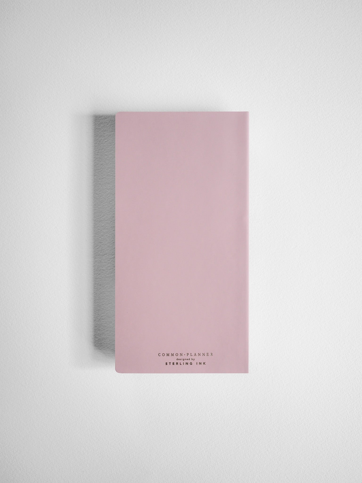 Minimalist blush pink planner cover featuring centered branding with "COMMON • PLANNER" and "STERLING • INK" for the 2026 academic year.