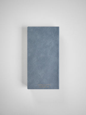 Muted dusty blue, textured planner cover featuring elegant, subtle gold embossing suitable for planning the 2026 year.
