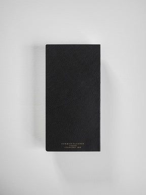 Luxurious, textured black planner cover featuring subtle gold branding and designed for comprehensive, full-year scheduling.