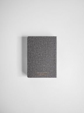 Textured gray compact planner with a horizontal design, featuring subtle centered gold lettering for a chic, unified aesthetic.