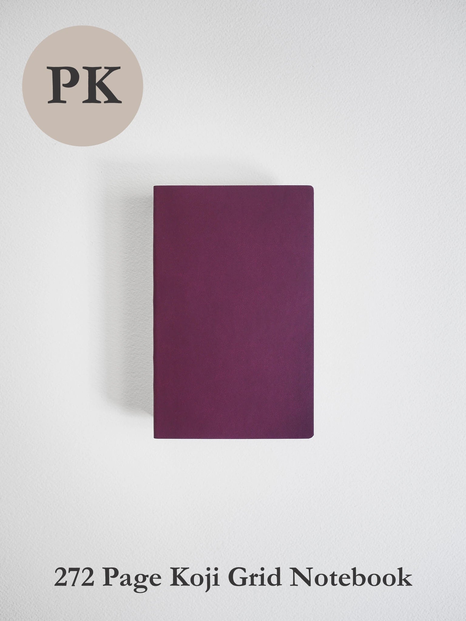 A dark purple grid notebook with a textured cover, centered on a light gray background. A beige circle in the top-left corner contains the letters 'PK', and the text '272 Page Koji Grid Notebook' is printed at the bottom.
#Color_Mulberry