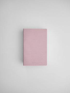 Simple dusty rose daily planner notebook with minimal black branding, designed for organization and journaling.