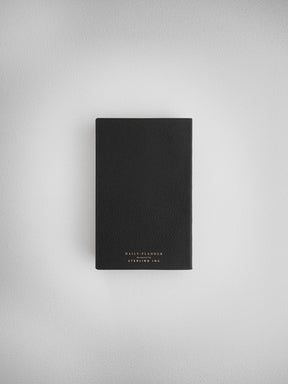 Matte black daily planner notebook with centered white typography branding that reads "Daily Planner" and "Steeling Ink."