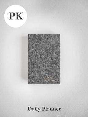 A textured charcoal daily planner designed for academic use, featuring the 2026-2027 branding on its compact cover.