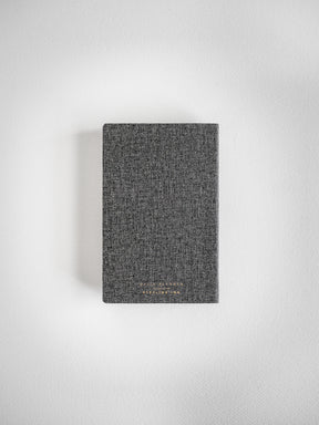 Dark gray, speckled fabric pocket daily planner for 2026, featuring a subtly textured cover design for organized planning.
