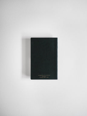 A sleek, black, vertical planner featuring centered white lettering that reads "Common Planner" and "Designed by Sterling Ink."