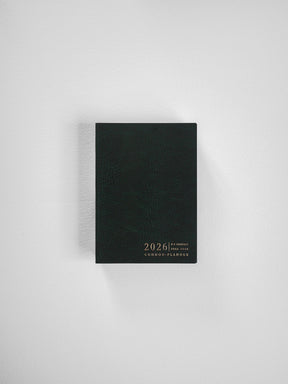 Vertical black planner with a textured cover, featuring elegant gold embossing of "2026" and "Common Planner," ideal for yearly organization.