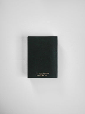 Sleek black vertical planner with a minimalist design, featuring elegant gold lettering on the cover that reads "Common Planner" and "Sterling Ink."