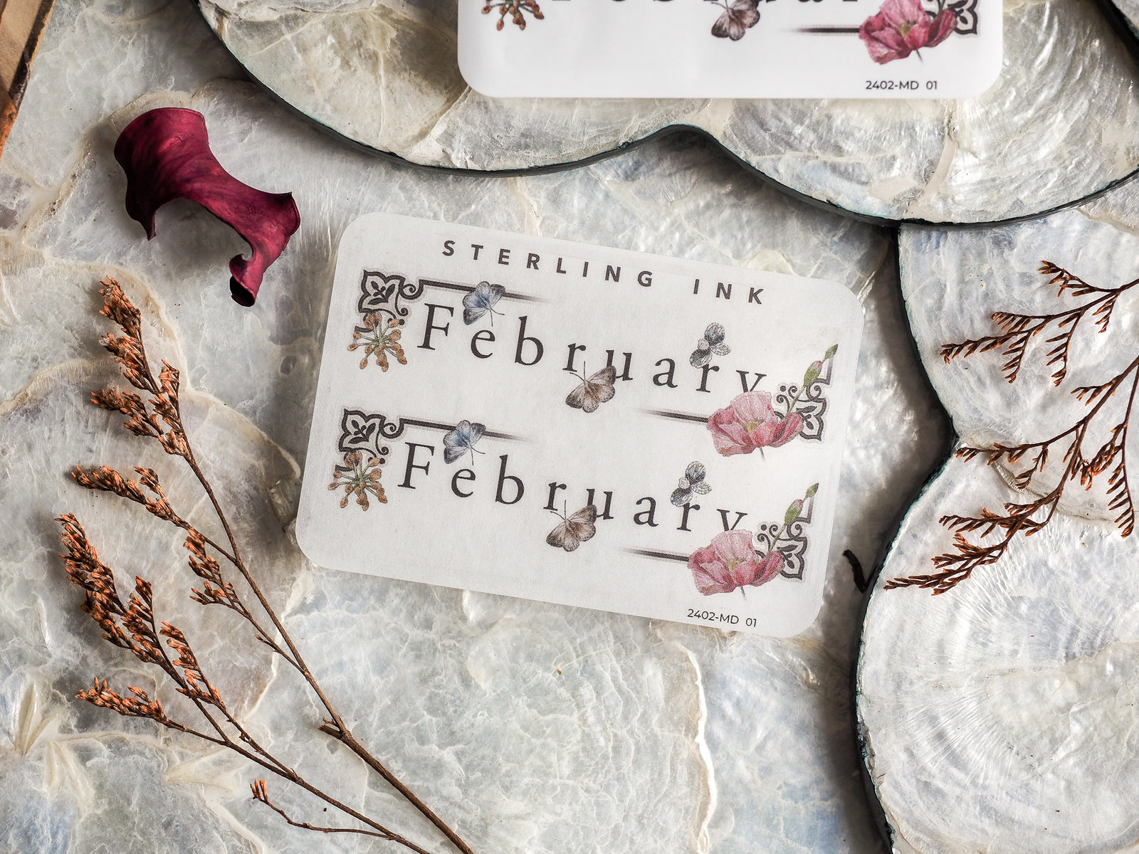 A sophisticated sticker displaying "February" framed by romantic watercolor florals, delicate vines, and elegant script lettering.