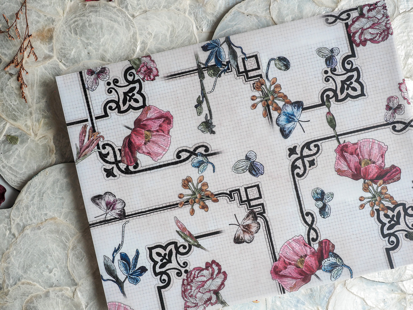 Elegant February 2024 planner spread featuring detailed black geometric borders framing soft watercolor illustrations of pink and blue flowers and delicate butterflies.