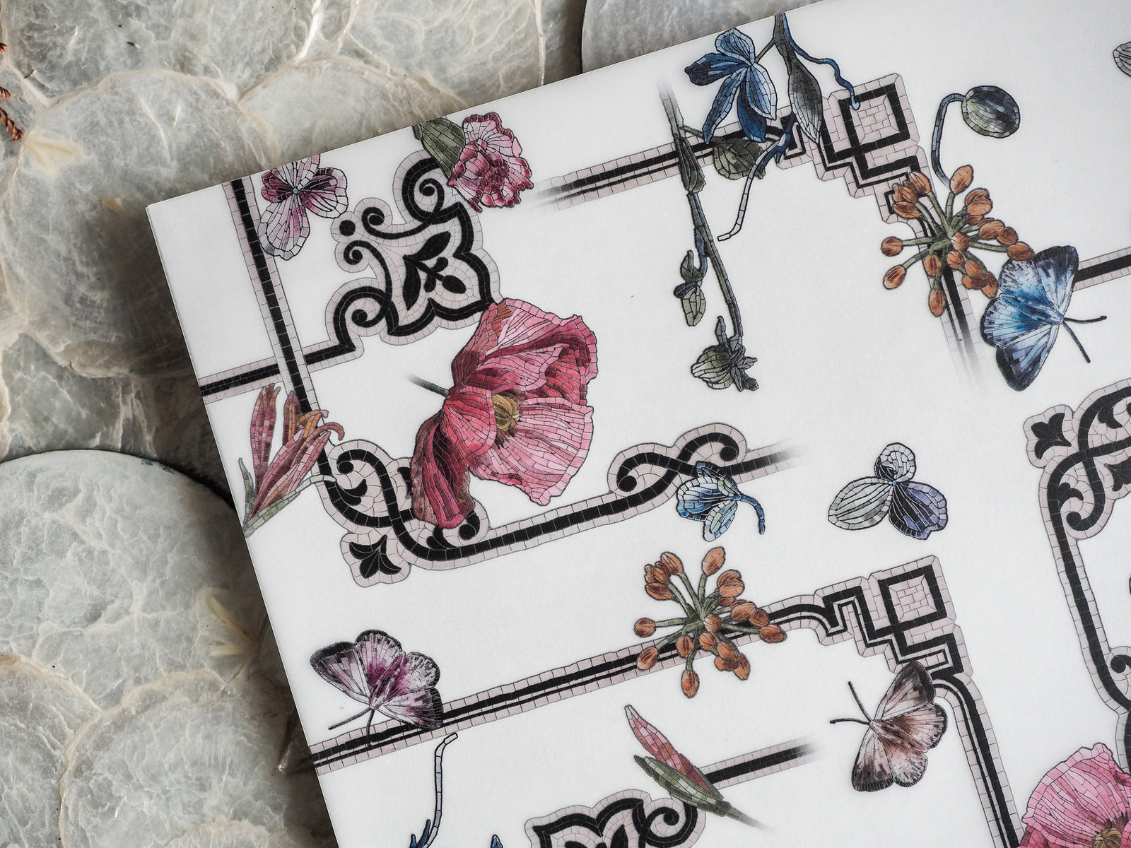 Elegant botanical pattern featuring watercolor renderings of pink poppies, blue blossoms, and brown clusters, framed by ornate black Victorian-style borders.