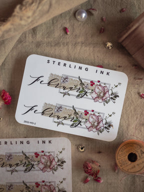 Elegant "February" month sticker featuring a delicate, romantic watercolor wreath of pink and blush roses and accompanying green foliage.