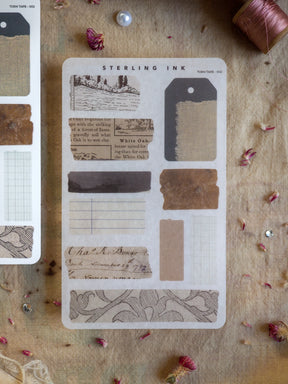 Vintage "Torn Tape" sticker set featuring rustic, historical designs like oak leaf sketches, ruled journal paper, and aged labels for scrapbooking and journaling.