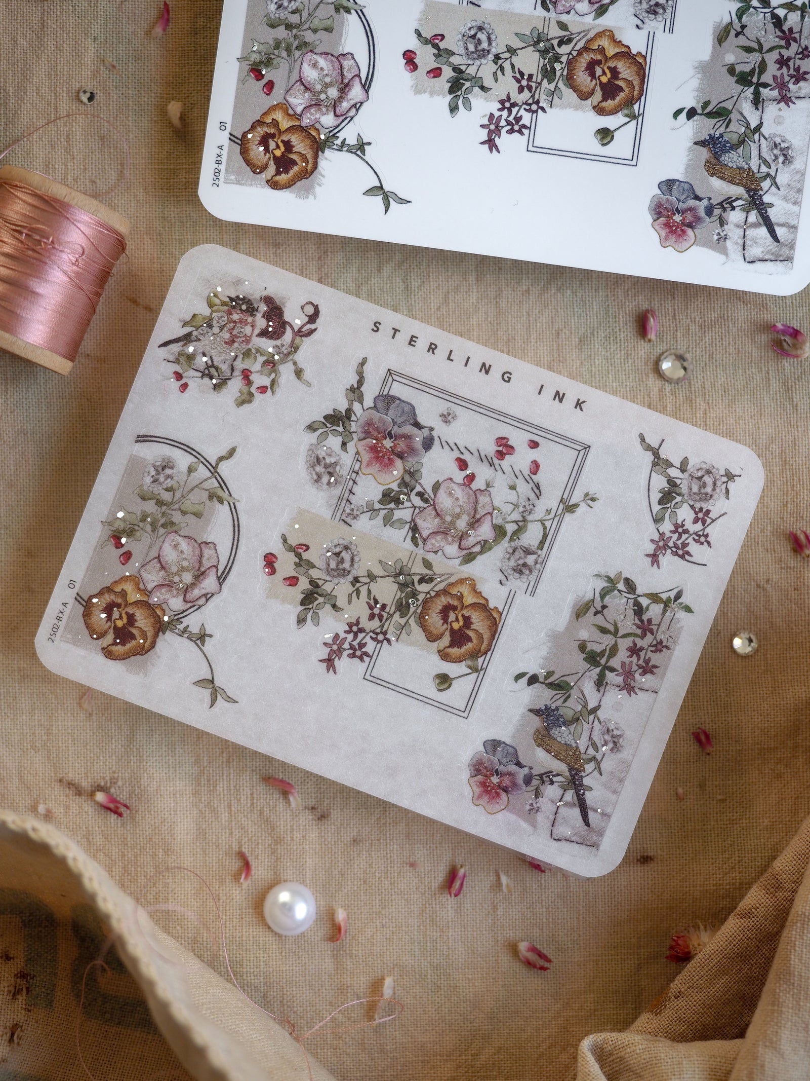 Elegant corner stickers featuring detailed, muted botanical illustrations with clusters of rustic flowers and delicate silver foil accents.