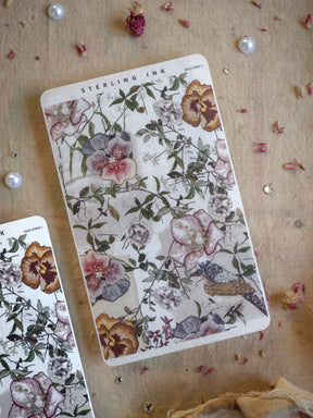 Watercolor floral sticker sheet featuring muted pink and brown blooms, delicate greenery, and a charming bird motif, perfect for journaling decor.
