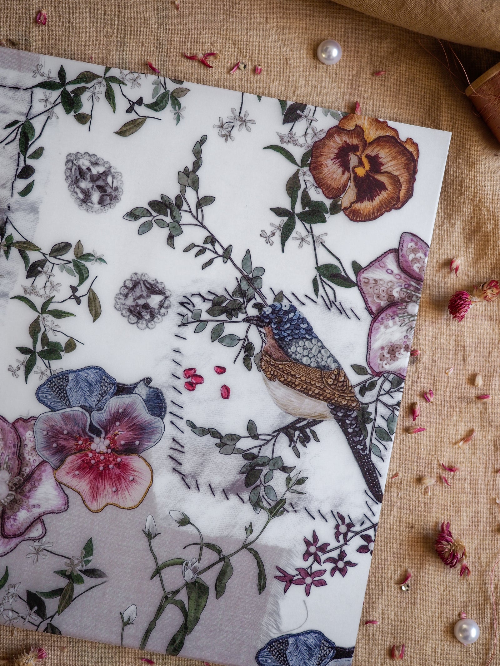 Detailed watercolor illustration featuring rich botanical motifs, tropical blooms, lush green foliage, and elegant depictions of colorful songbirds.