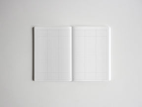 Open spiral sketchbook displaying pristine graph paper grids, ideal for technical drawing, precise journaling, or architectural planning.