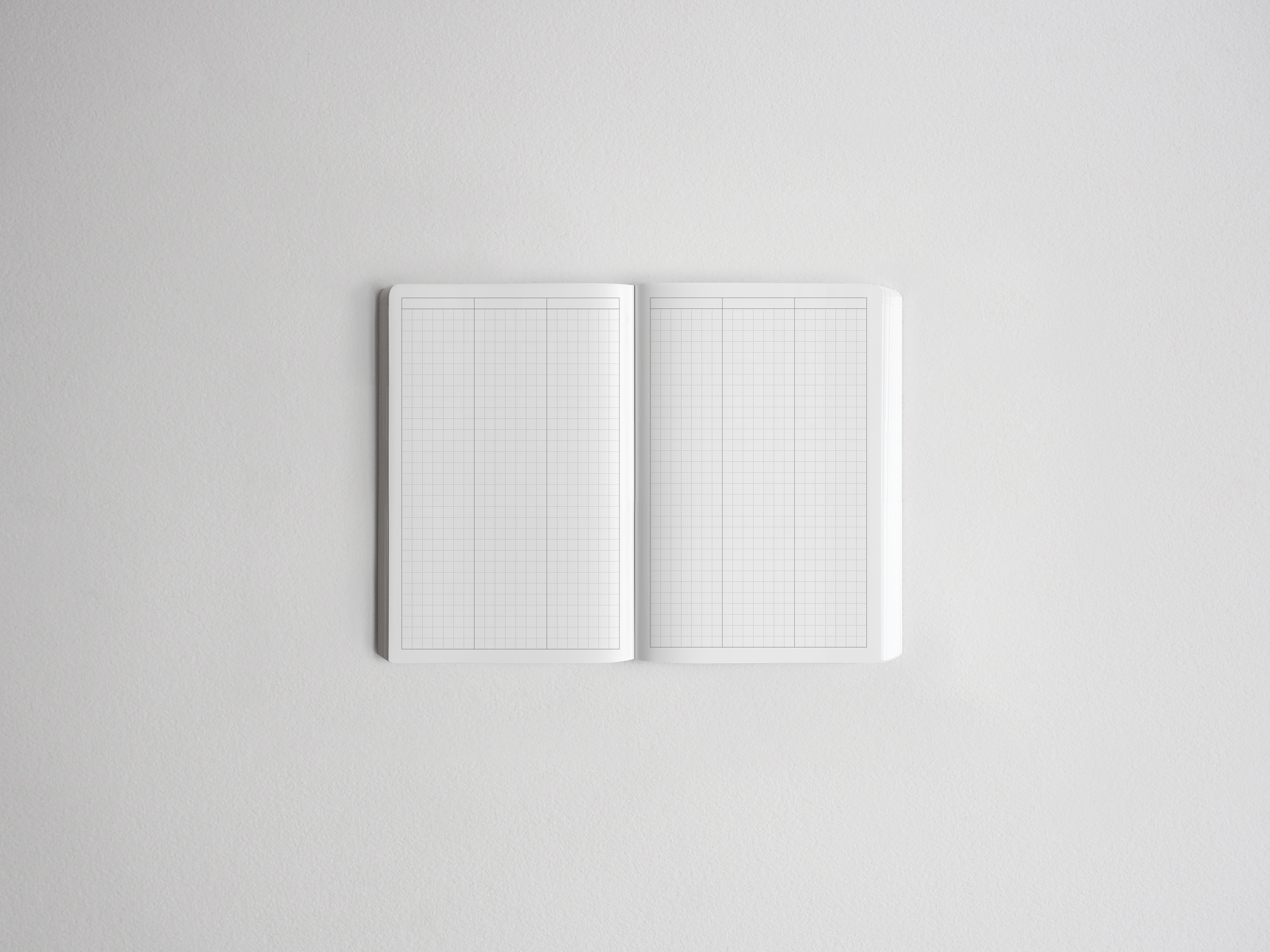 Open sketchbook featuring double-page graph paper, displaying precise grid lines ideal for technical drawing, journaling, or academic planning.