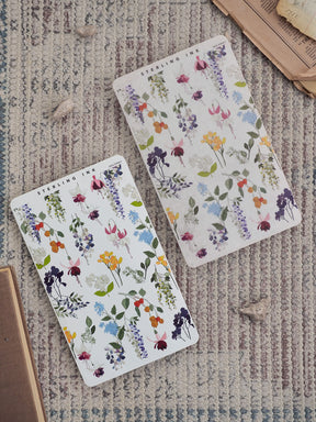 Watercolor-style sticker sheets featuring a romantic, dense floral pattern of purple, pink, and yellow blossoms mixed with vibrant green foliage.