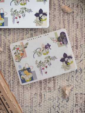 Botanical sticker sheet featuring clusters of deep purple and green flowers, perfect for adding natural, delicate accents to journals and planners.