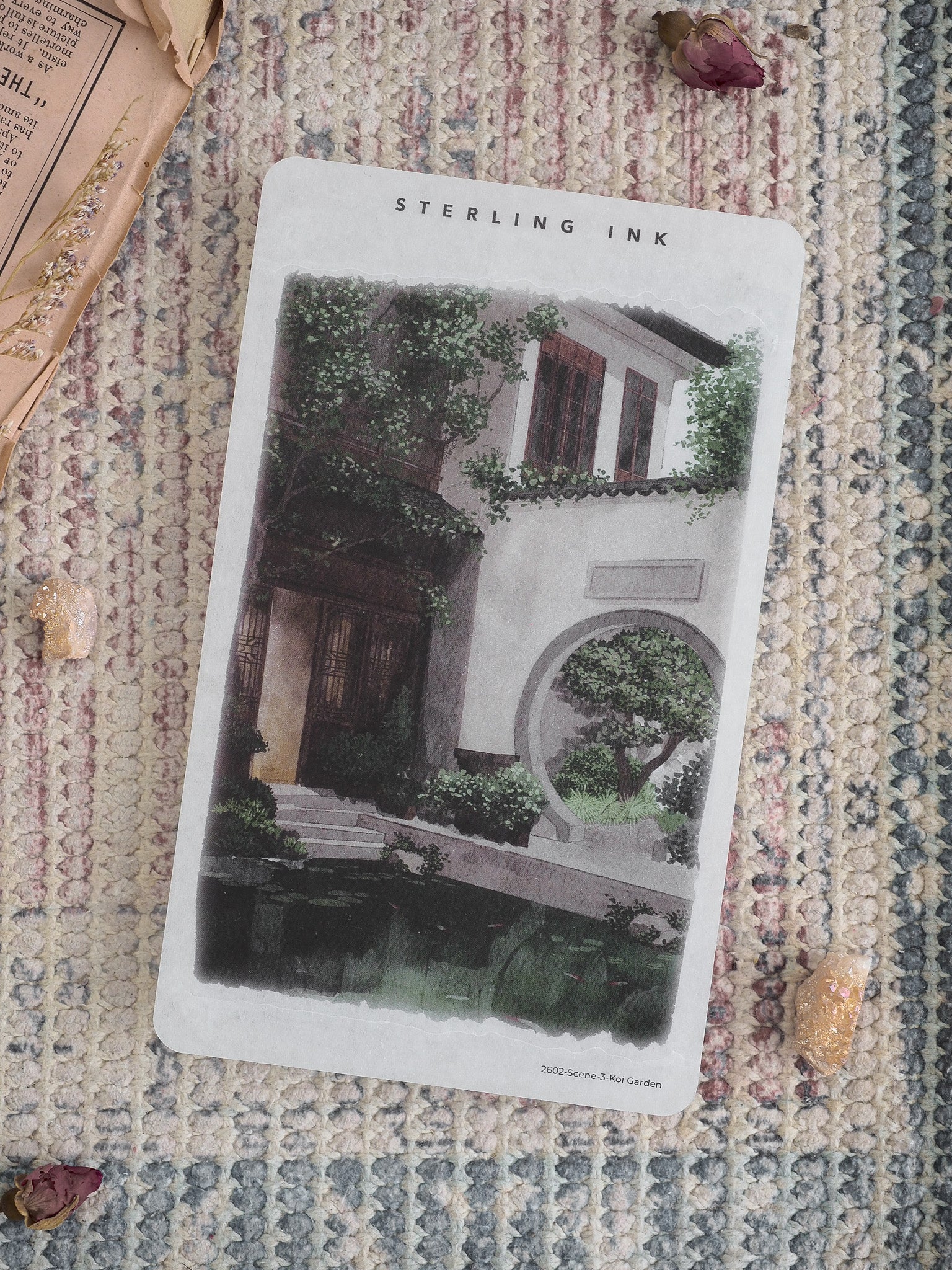 A sticker depicting a serene, lush Koi Garden scene, featuring traditional architecture, greenery, and a peaceful central courtyard.