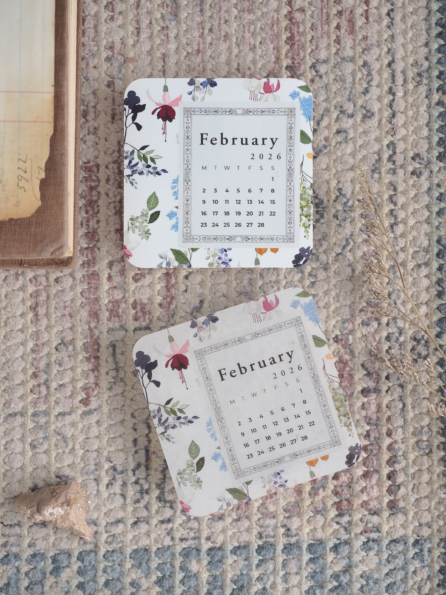 Floral calendar set for February 2026, featuring elegant monthly layouts bordered by delicate pink and deep purple blossoms.