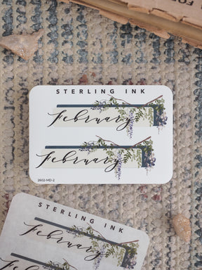 Rustic February planner sticker featuring elegant script and delicate watercolor vines of green foliage and purple blossoms.