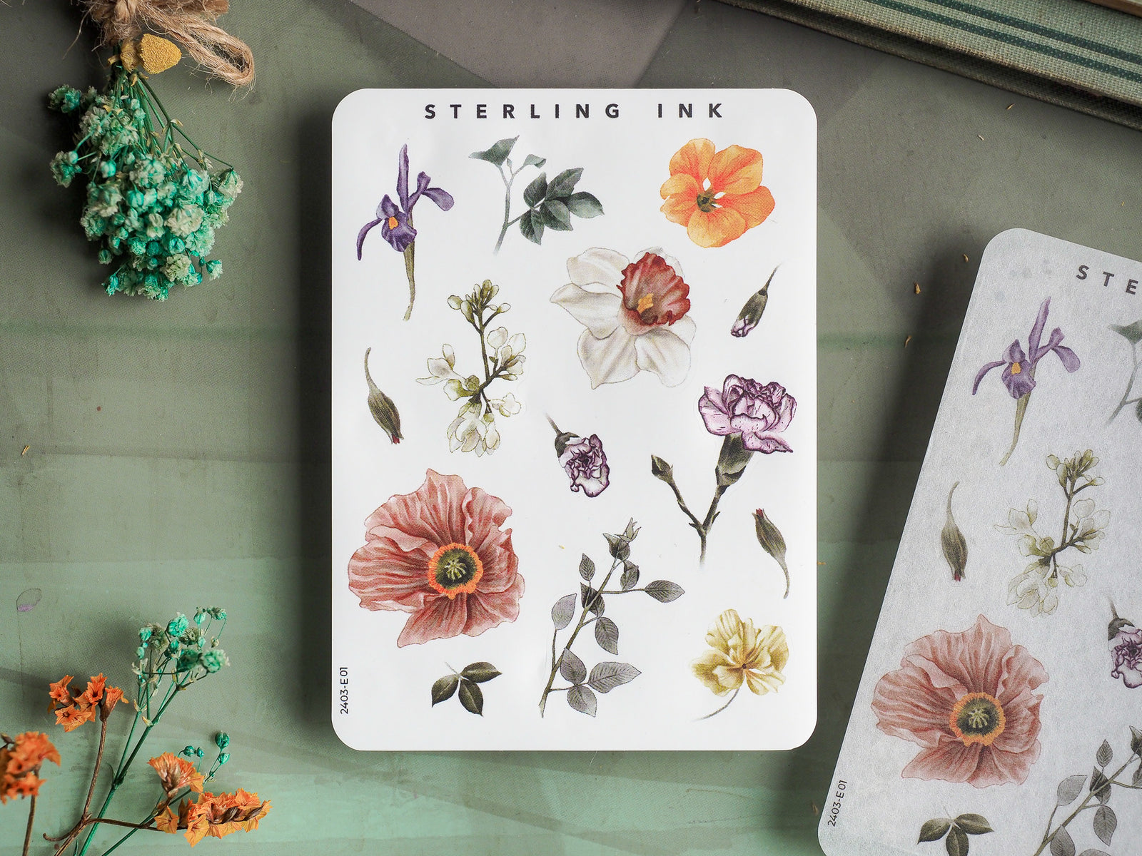 Watercolor sticker elements featuring a rich collection of botanical illustrations, including deep purple irises, blush peonies, and bright orange blooms.