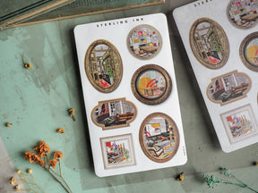 Vintage-themed sheet of die-cut sticker frames, filled with ornate illustrations of cozy, detailed interiors, perfect for decorating planners and journaling.