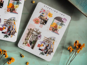 White notepad showcasing a grid of vibrant, illustrative sticker designs featuring architectural collages and colorful interiors, branded "STERLING INK."
