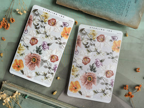 Intricate floral sticker sheets featuring a delicate watercolor pattern of blooms in soft blush, warm orange, and creamy pink tones.