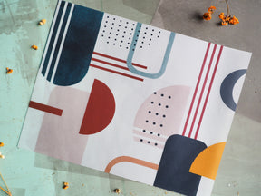 Abstract geometric design featuring overlapping semi-circles and rectangles in deep navy, terracotta, dusty rose, slate blue, and mustard yellow, titled Vellum - March 2024.